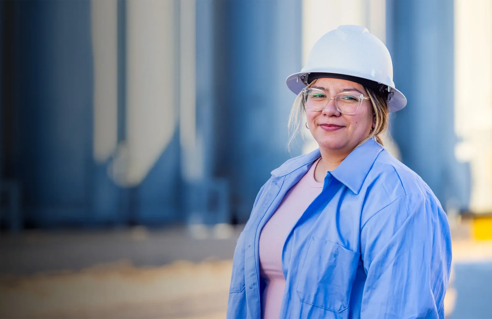 Woman in hard hat smiles